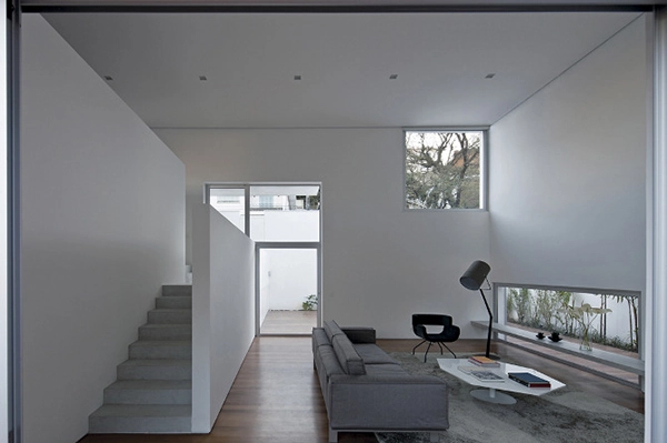 Double-height living room space view from backyard