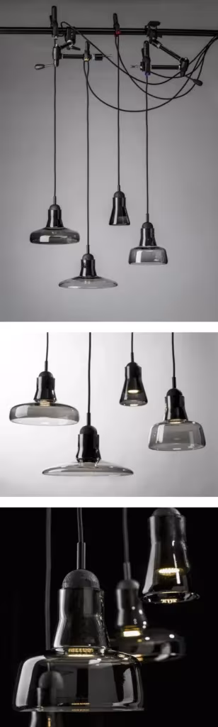 Colección de lámparas colgantes Shadows de cristal ahumado agrupadas en distintas alturas
