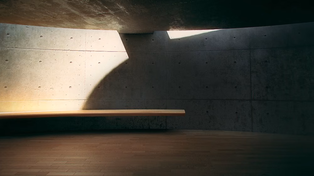 detalle del interior Haz de luz natural sobre un muro de hormigón visto en el interior en penumbra de la Casa Koshino