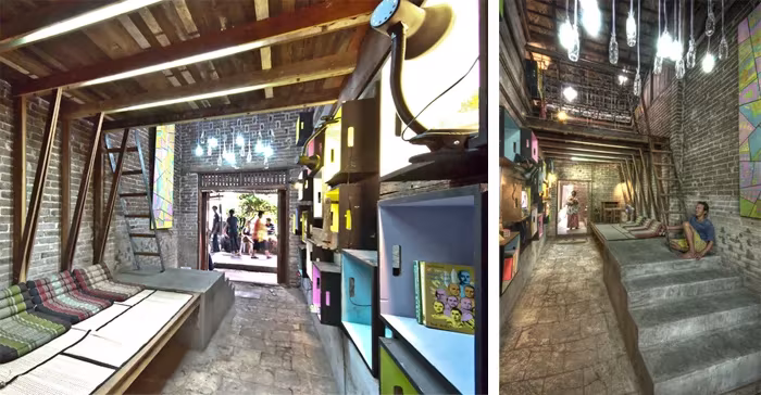 3 Interior de madera y ladrillo de la biblioteca de Bangkok con asientos, estantes de colores y escalera