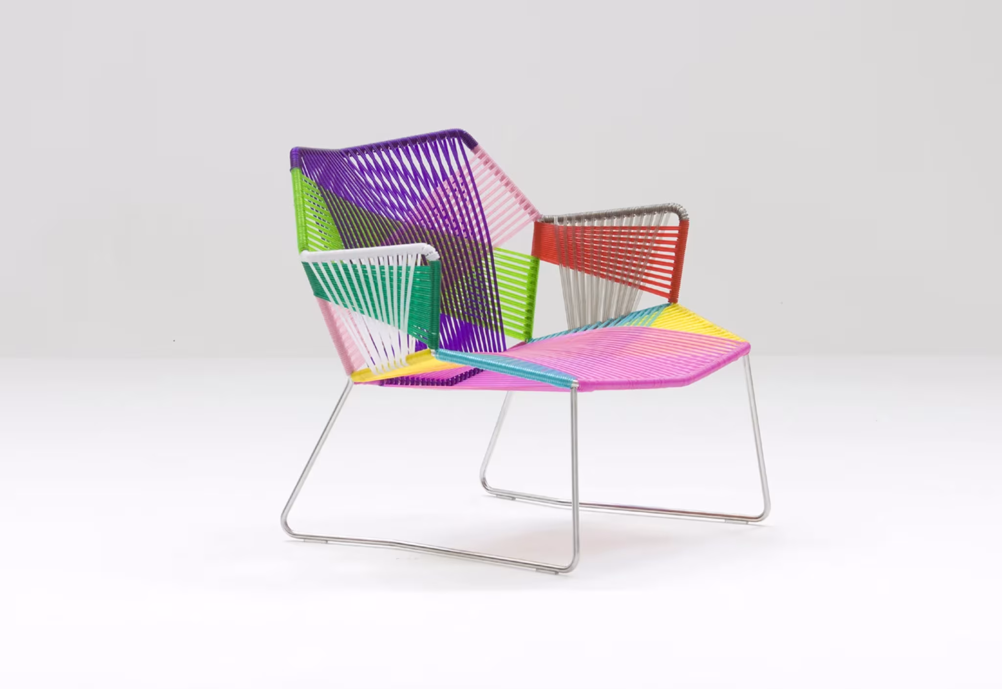 Butaca Tropicalia de Patricia Urquiola para Moroso con cordones trenzados de colores sobre estructura de acero