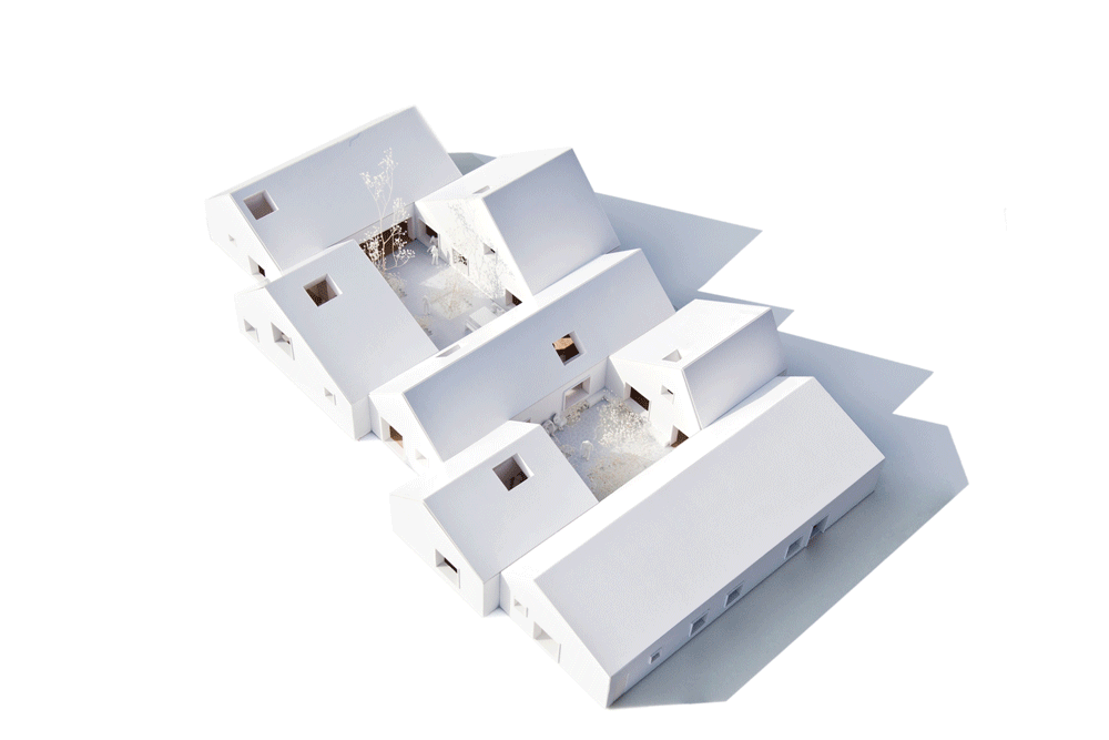 Maqueta axonométrica blanca de Livsrum con las casas seccionadas para mostrar los espacios interiores