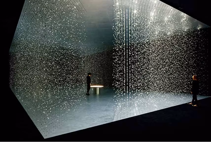Caja de luz de time is TIME en Milán llena de piezas suspendidas brillantes con visitantes dentro