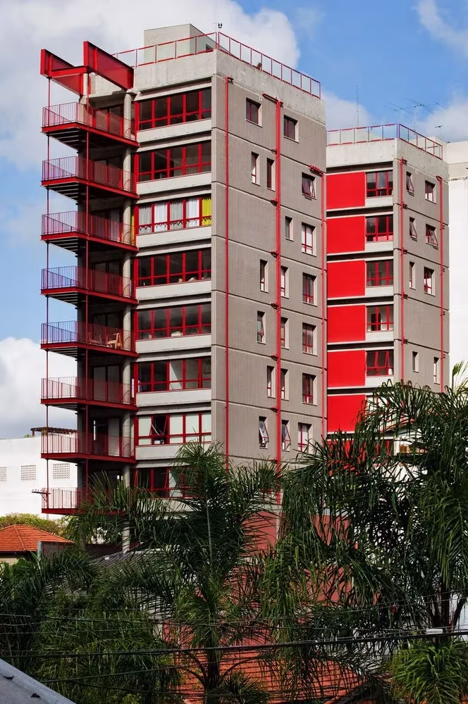 Torre residencial de hormigón con balcones y escaleras de acero rojo en el edificio de la Rua Simpatia, São Paulo