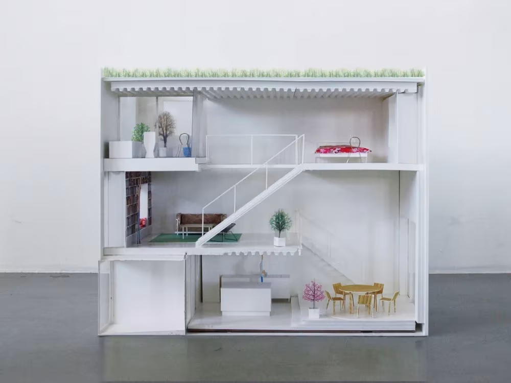 Maqueta seccionada de la Townhouse de Elding Oscarson con cubierta ajardinada y escalera inclinada entre plantas