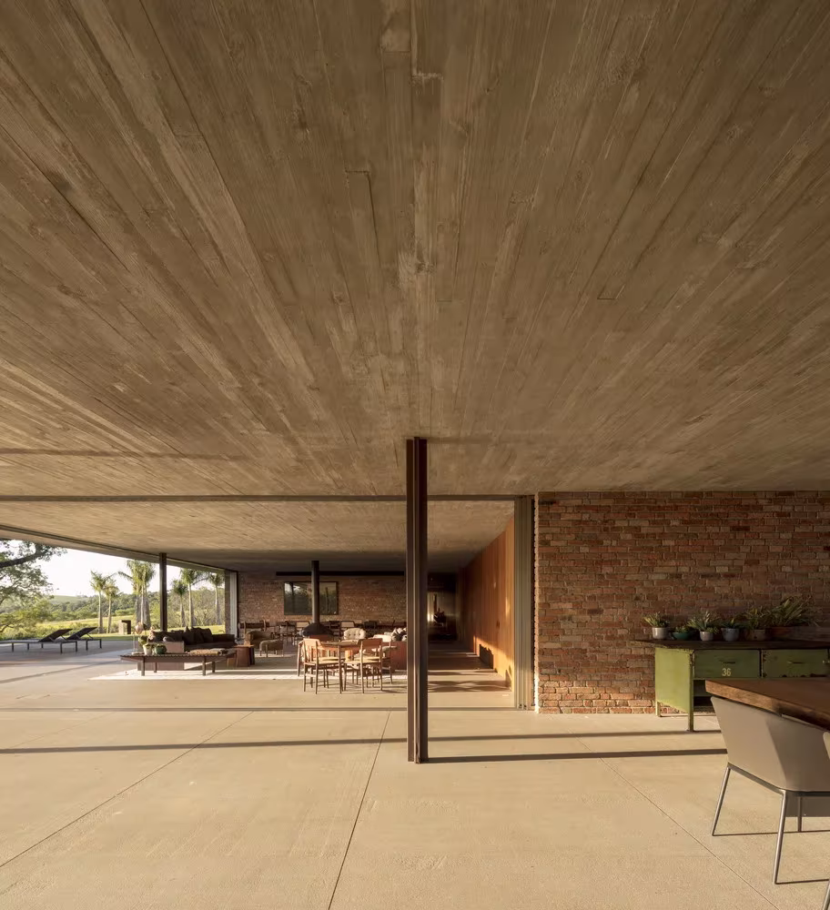 Estancia diáfana de la Casa plana con techo de hormigón encofrado, pilares finos y muro de ladrillo, MK27