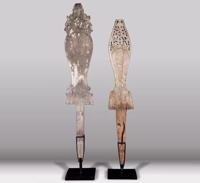 Dos tallas antiguas de madera de Borneo sobre peana negra, con motivos calados
