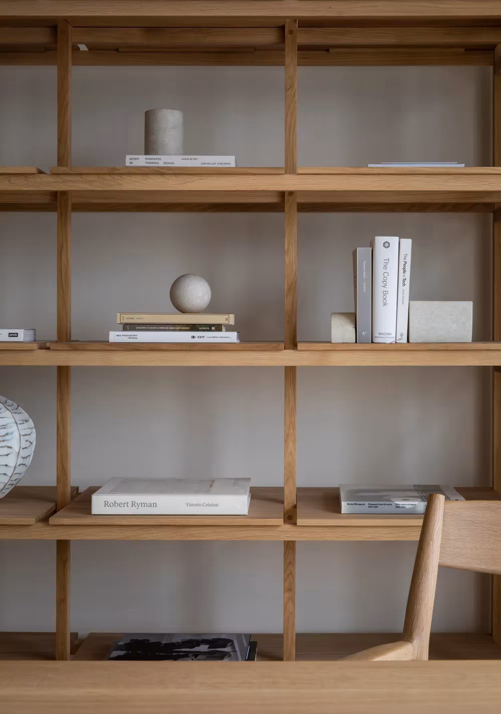 Estantería de roble con libros y objetos de cerámica en Kinuta Terrace, de Norm Architects y Keiji Ashizawa