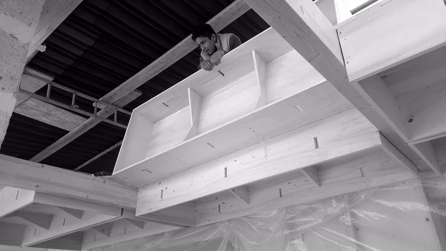 Estructura de nervios de contrachapado cortados por CNC en el forjado de la Plywood House, en blanco y negro