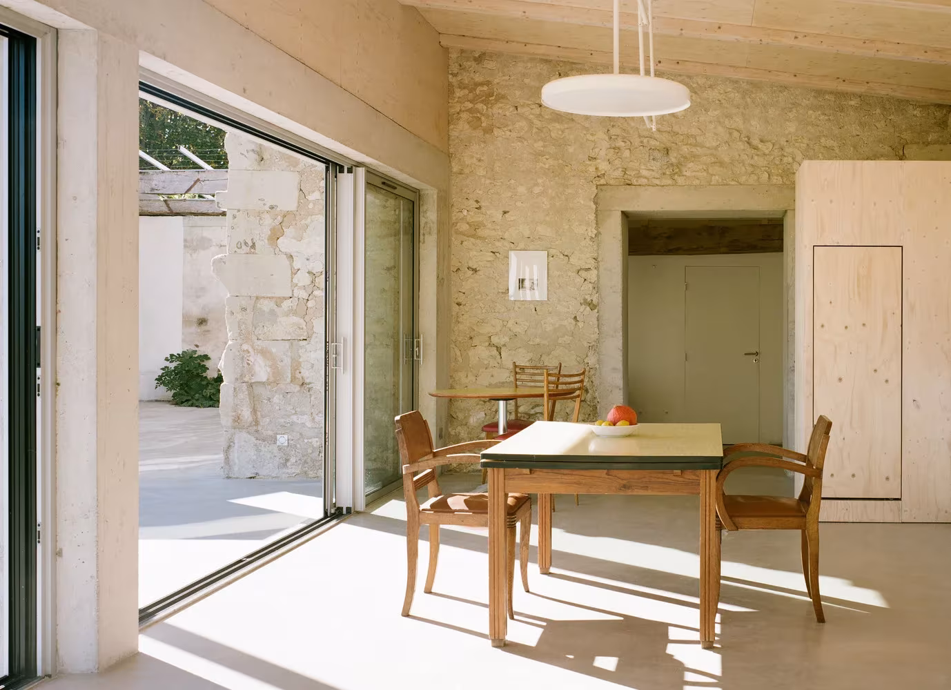 Detalle interior mesa de comedor de la transformación de un granero en una casa de vacaciones en Francia de Migeon Architecture. 