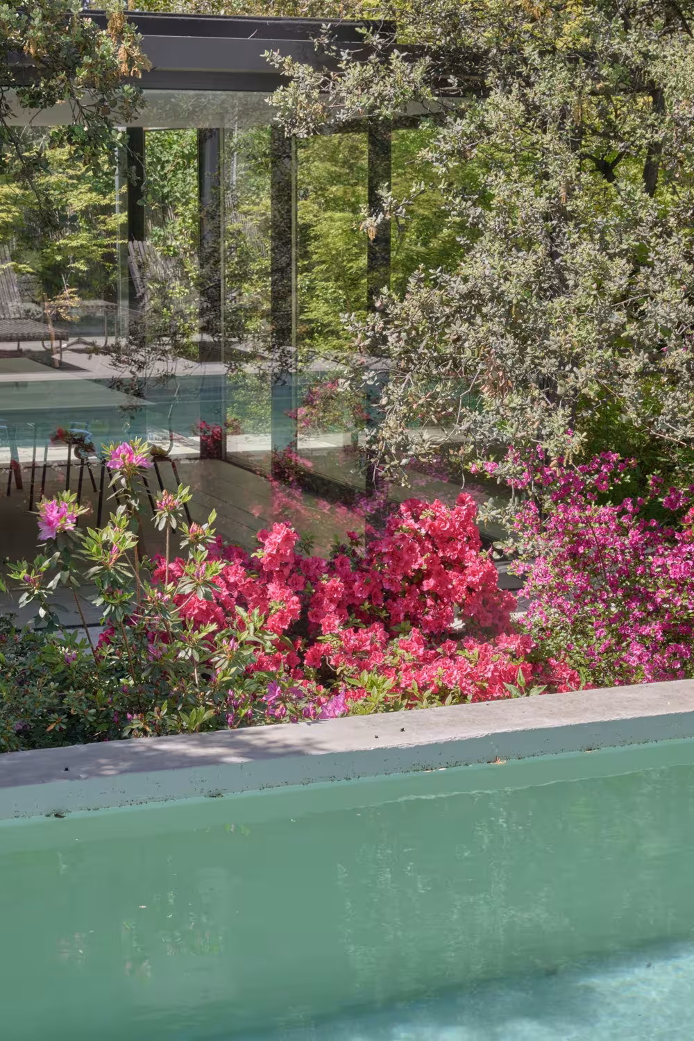 ABATON-pabellon-del-jardin-1 Pink azaleas beside a green-tiled pool with the glazed pavilion behind, Pabellón del Jardín