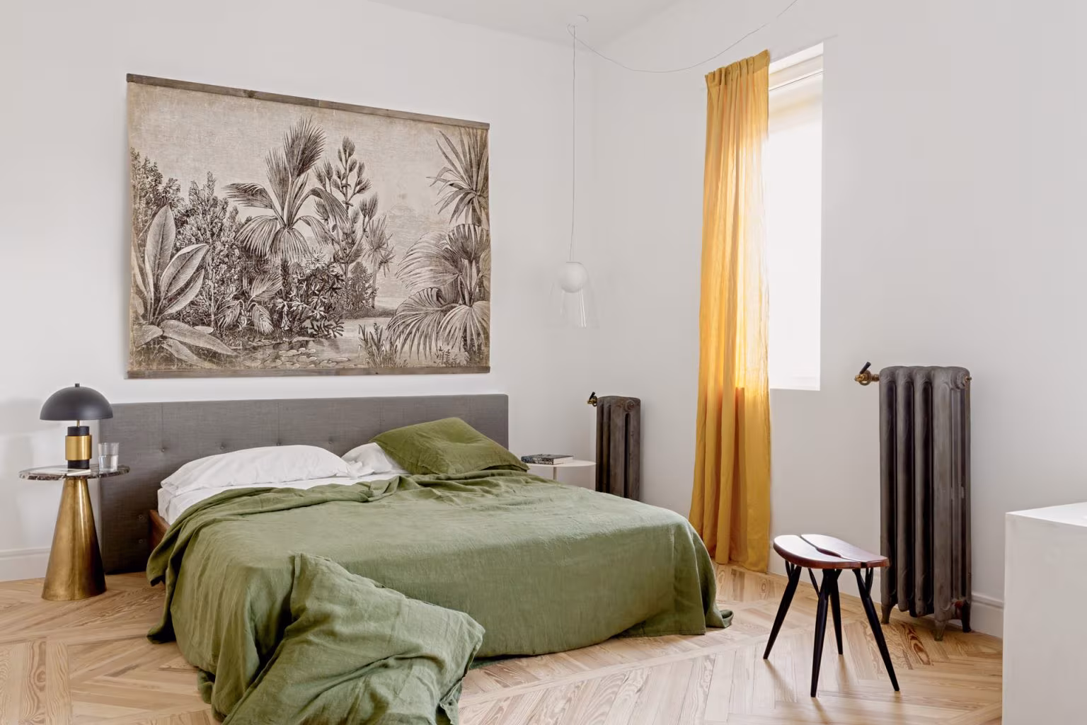 Bedroom with green bedding, grey headboard, ochre curtains and a botanical print in the Sagasta II refurbishment
