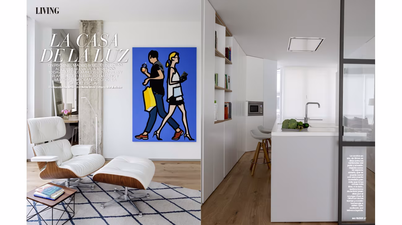 Marie Claire Maison opening spread with a classic leather lounge chair, a blue pop art painting and a white kitchen