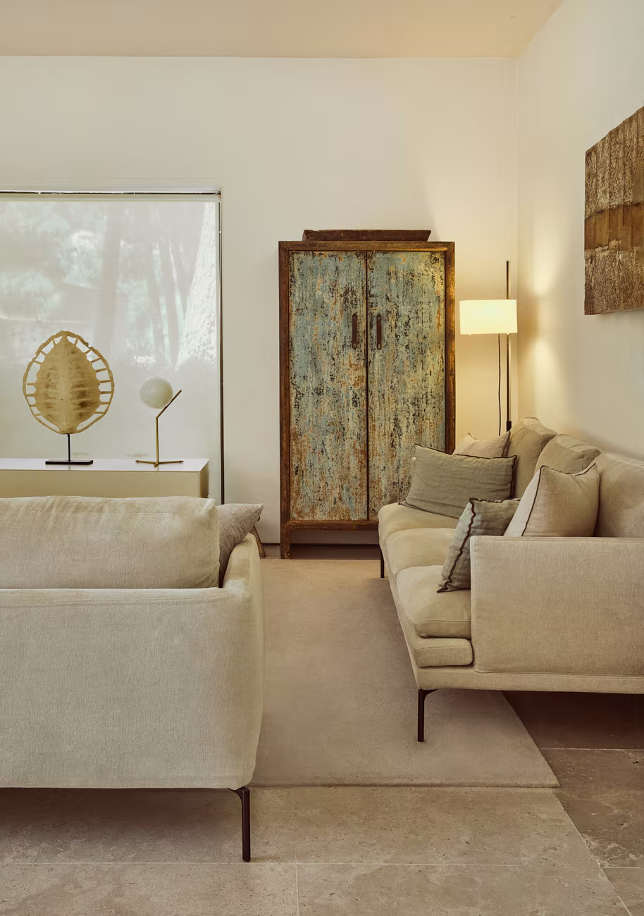 Sitting room with two pale sofas, painted antique cabinet and floor lamp, Casa Oviedo