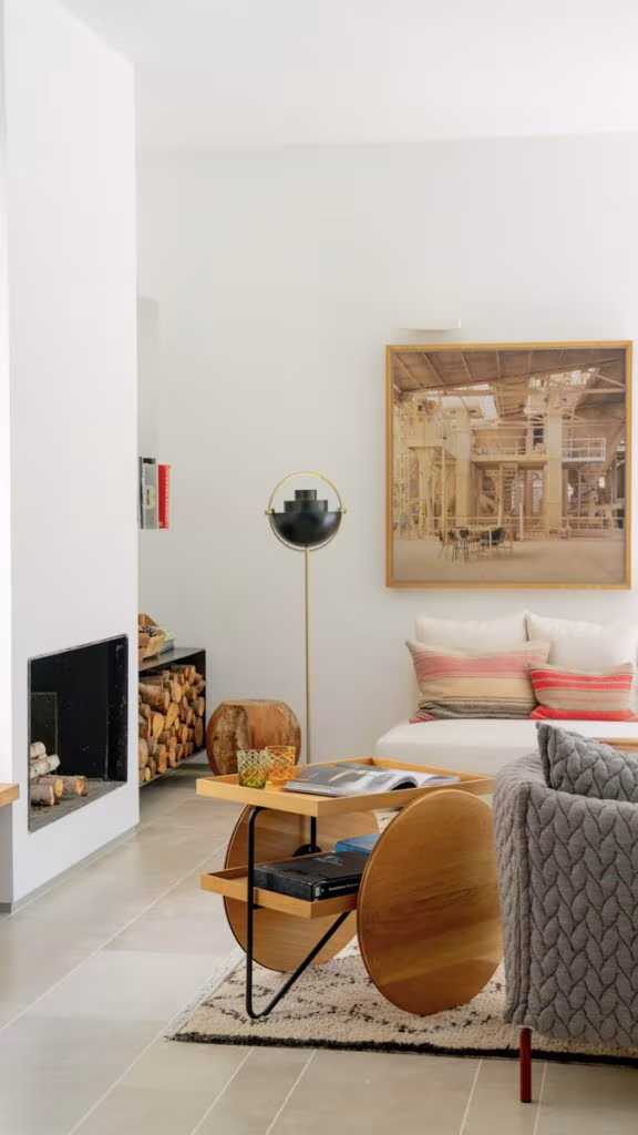 Sitting corner with fireplace, sofa, designer coffee table and large painting, Ábaton studio, Madrid