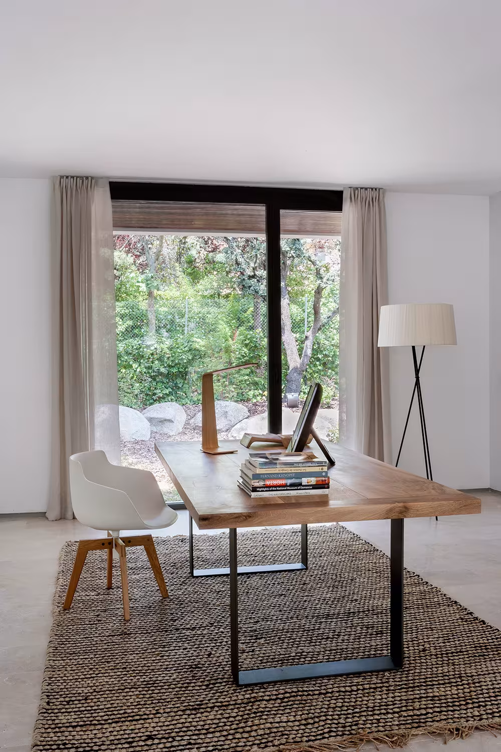 La Moraleja-ABATON-10 Study with timber desk on metal legs, white chair and jute rug before a large window, La Moraleja