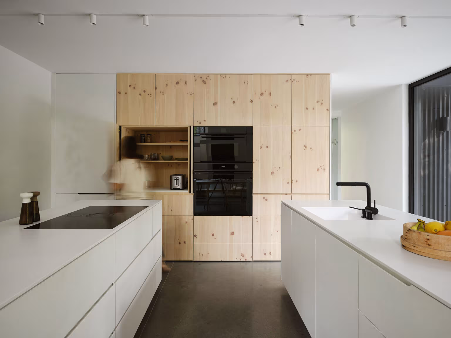 White kitchen with a pine cabinet wall and built-in oven in TISSARAOUATA