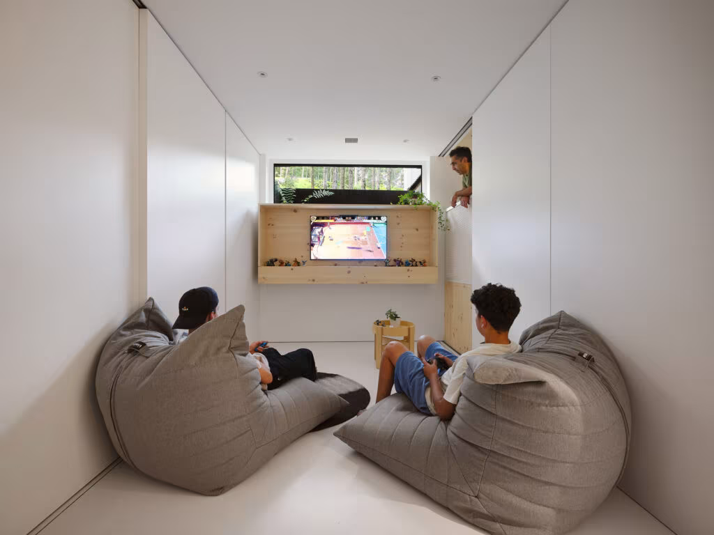 Play room with two large beanbags and a screen set into a timber niche, TISSARAOUATA