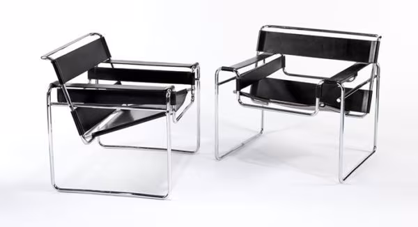 Two Marcel Breuer Wassily armchairs in black leather with a chromed tubular frame