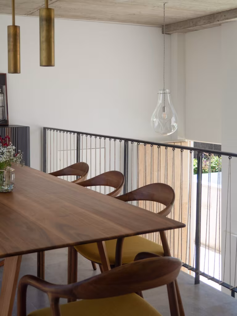 OLYMPUS DIGITAL CAMERA Walnut table with yellow-upholstered timber chairs beside the stair balustrade in Project PC