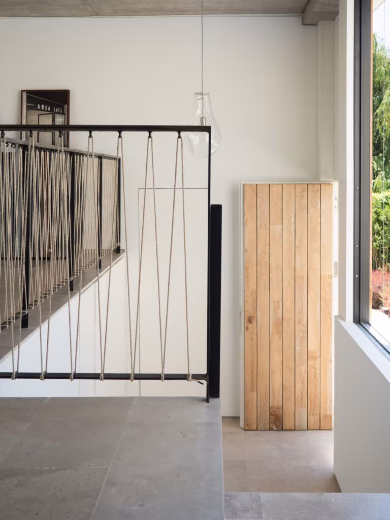 OLYMPUS DIGITAL CAMERA Crossed-rod metal balustrade and a plank oak door before a window in Casa de las encinas