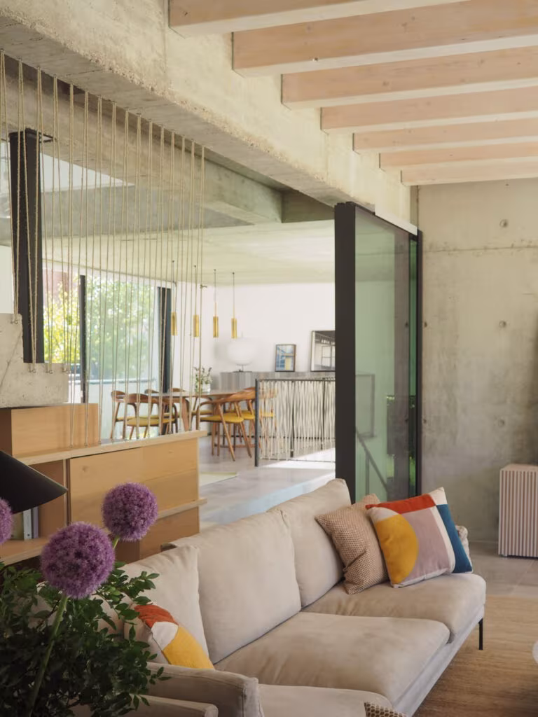 OLYMPUS DIGITAL CAMERA Living room and kitchen in a single space behind glazing with concrete structure and timber beams in Project PC