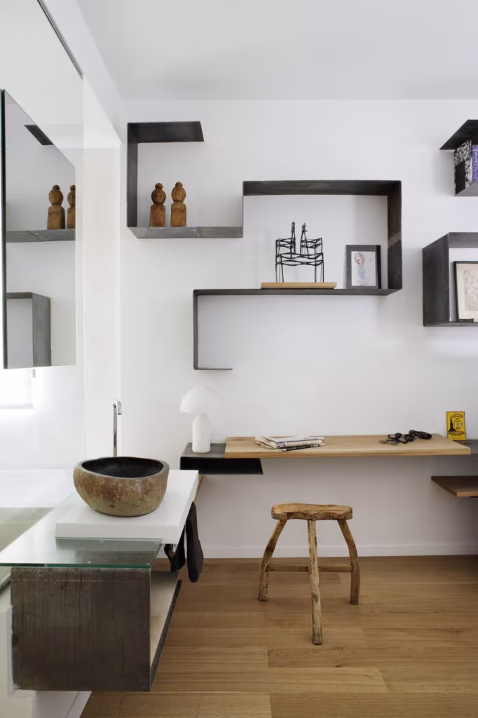 Timber desk and stepped black steel shelving with a rustic stool in the Rosales home