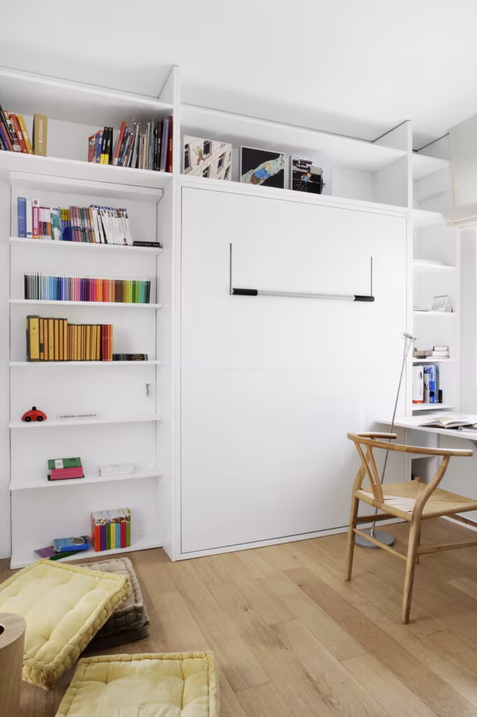 White bookcase with fold-down bed and desk in a room of the Rosales refurbishment by Ábaton