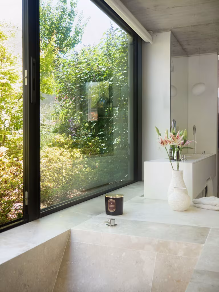 Montegancedo-187 Sunken stone bath before a large window opening onto the garden in Project PC by Ábaton