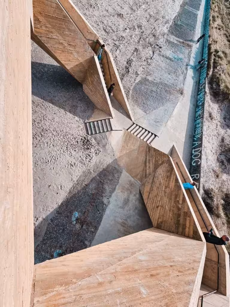 Vista desde lo alto de la escalera de Westerpunt hacia el dique y la arena de la playa
